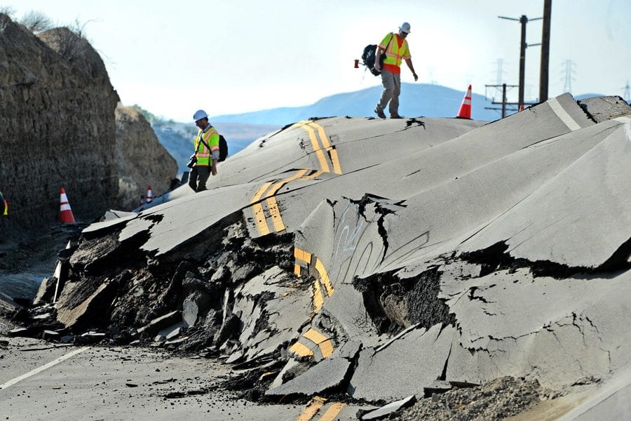LA County Engineering Geologists climb on top of the buckled road where Vasquez Canyon Road has lifted up due to soil movement closing the road between Saugus and Canyon Country. Photo taken in November 2015 by Dan Watson, The Signal.