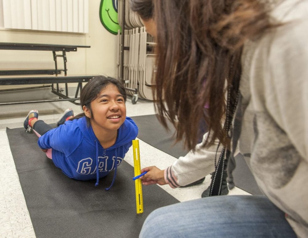 Newhall Elementary fifth grader Yaritzi Soroa demonstrates a trunk lift exercise during the Fifth Grade Health Night at the school. Photo Tom Cruze/For the Signal